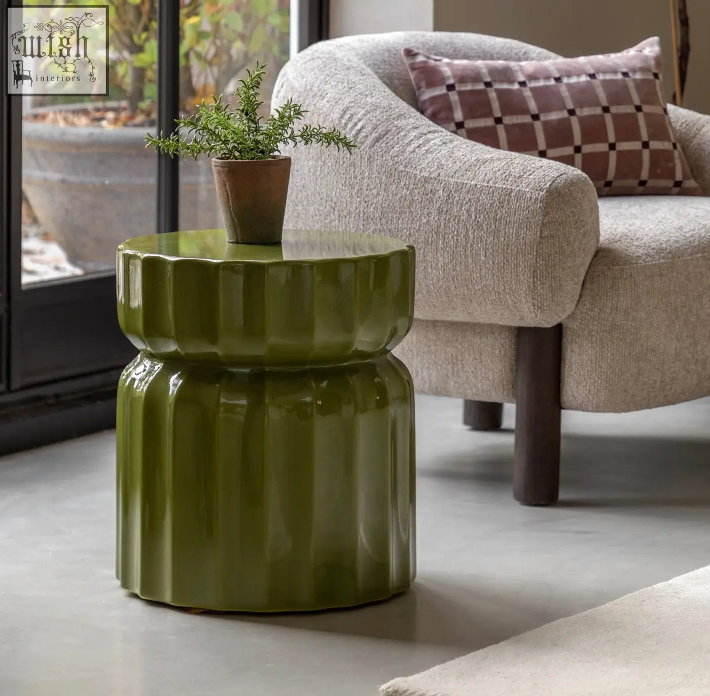 Celino side table in olive green ceramic with modern ridge pattern and green glazed finish featuring a fluted design
