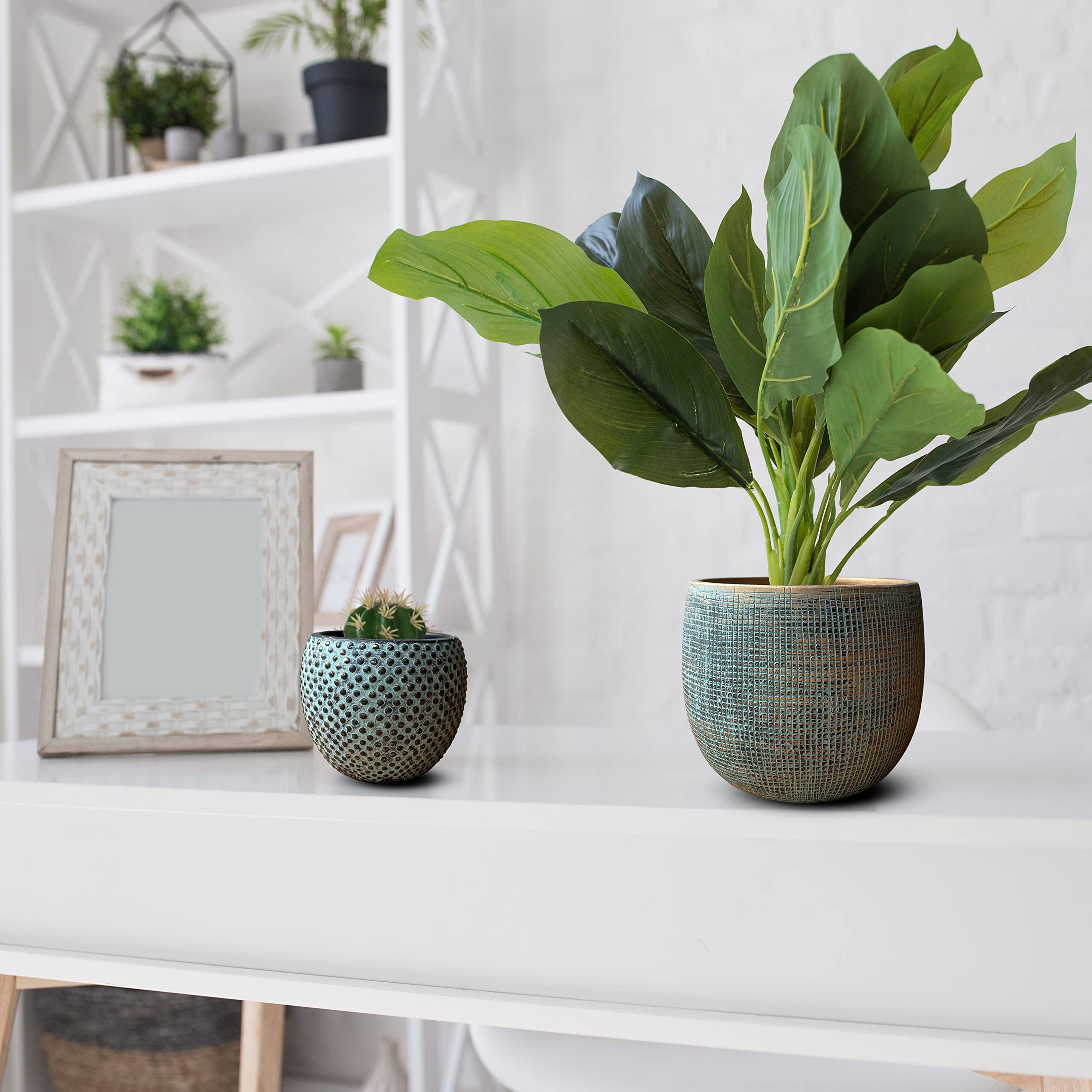 Textured teal ceramic plant pot from a green gold plant pot set with lush green leaves for indoor use