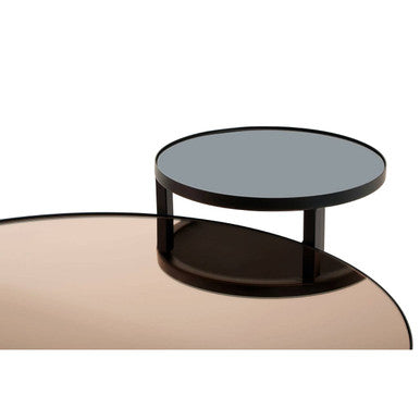 Black smoked mirror tier coffee table with glass top and sleek metal frame in minimalist modern design