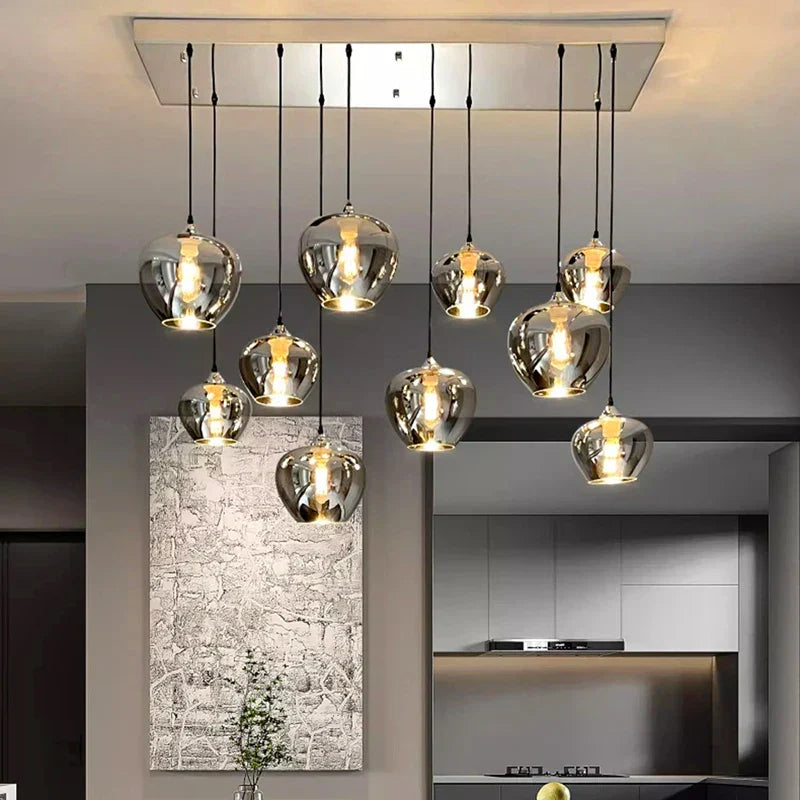 Modern chrome-finished glass pendant lights with warm white glowing bulbs for dining room chandelier lighting fixture
