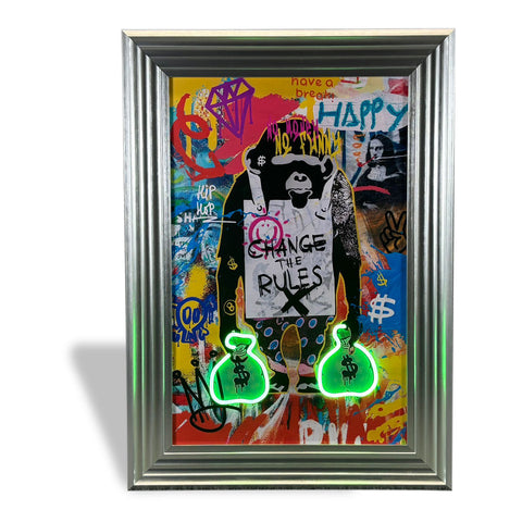 A vibrant graffiti-style framed artwork called change the rules featuring a black monkey holding a sign with neon green money bags