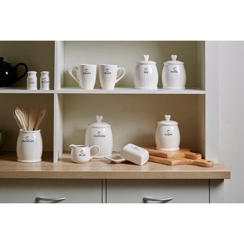 White dolomite sugar canister set with heart-shaped lids and black printed labels for charming kitchen storage
