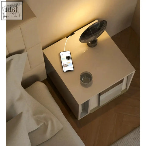 Beige chatterjee bedside table with sleek minimalist design and integrated drawer compartments and book holder