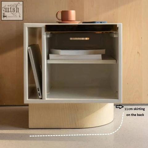 Modern white chatterjee bedside table with curved wooden base and glass front storage for book holder use