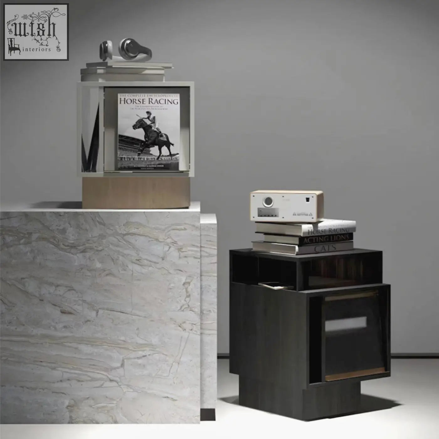A sleek white projector with a circular lens sits on a chatterjee bedside table with a built in book holder