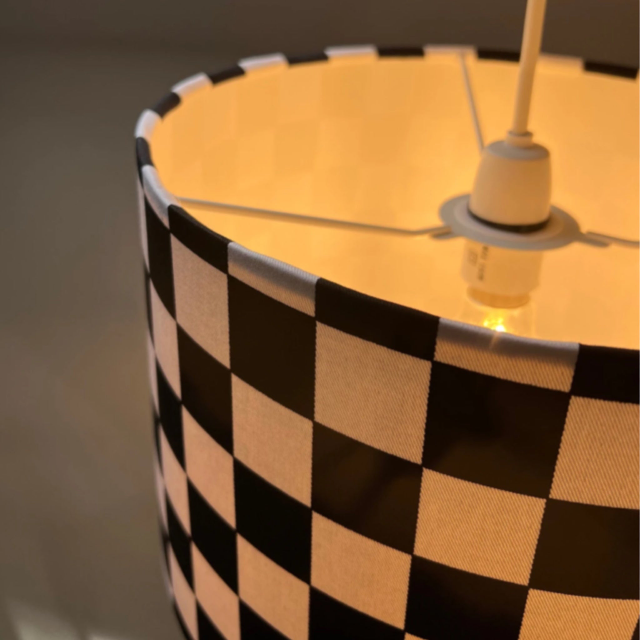 Black and white checkered cotton drum lampshade 30cm height with warm glow and white lining for ceiling use