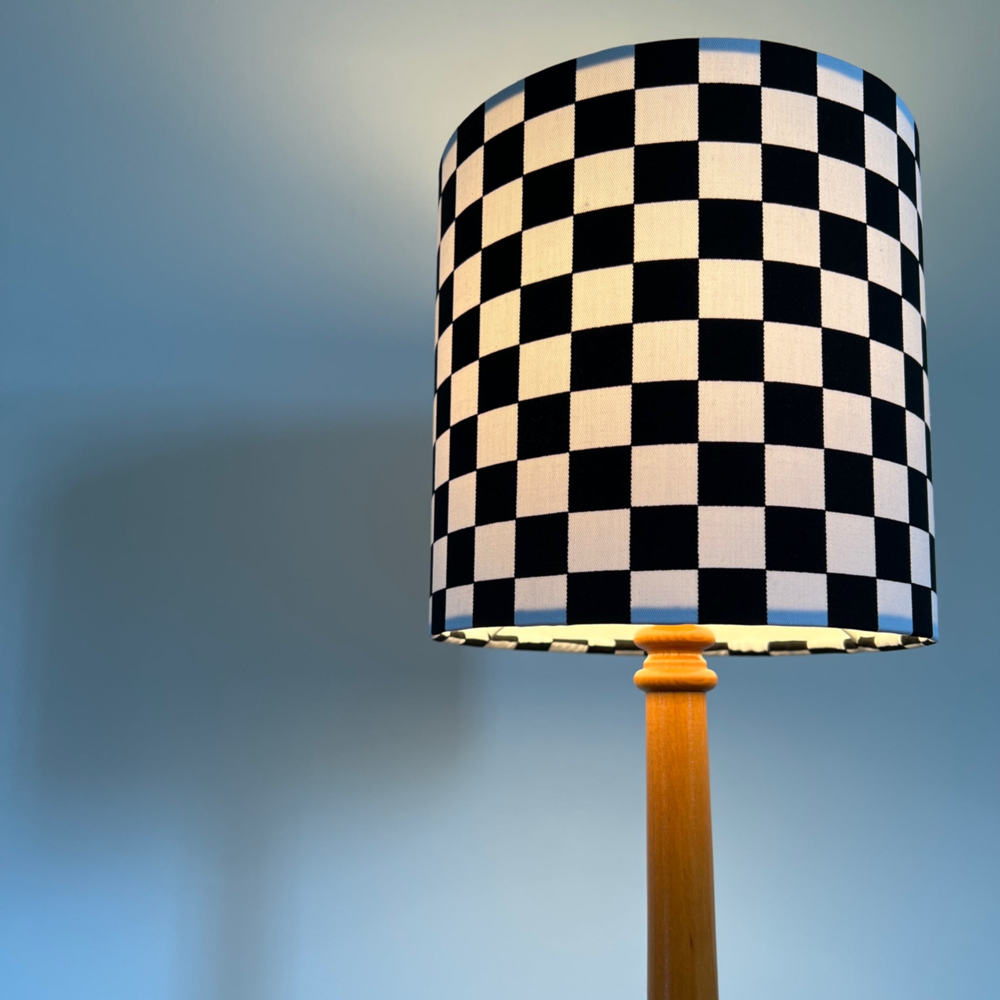 Black and white checkerboard cotton drum lampshade with wooden base 30cm height and white lining