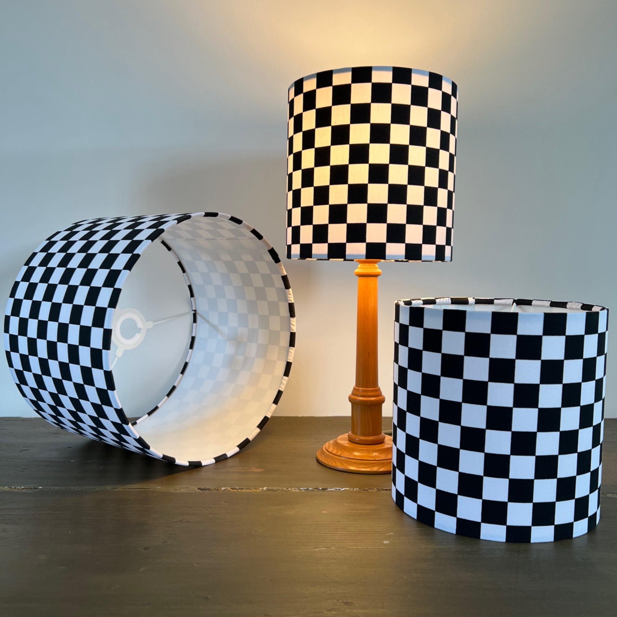 Black and white checkerboard cotton drum lampshade with wooden base 30cm height and white lining ceiling shade