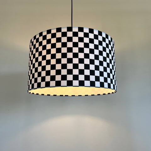 Black and white checkered cotton drum lampshade with 30cm height and warm interior glow ceiling shade