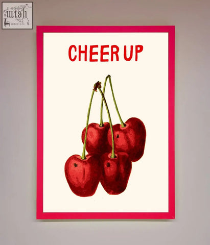 A vibrant pink cherries framed wall art with glossy red cherries and bold red cheer up text on a cream background