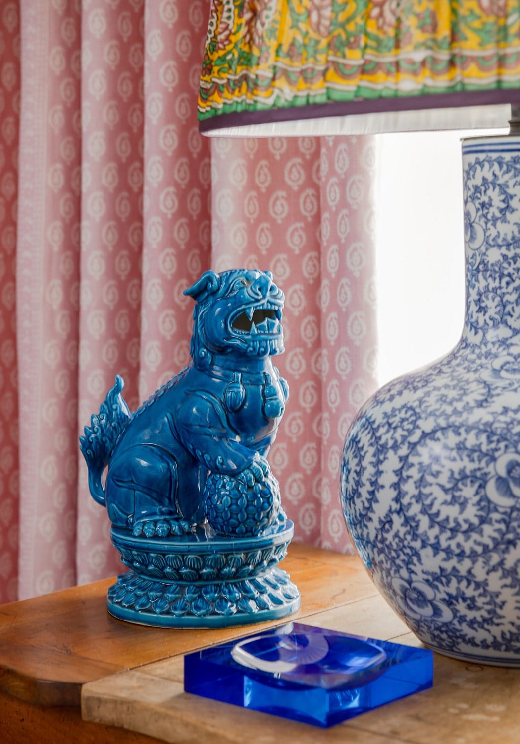 Vibrant cobalt blue ceramic lion figurine with glossy finish on chelsea cobalt glass trinket tray in blue