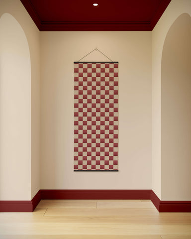 A red and cream checkered chequerboard wall tapestry with a black border perfect for home decor