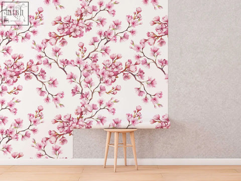 Pink cherry blossom mural with delicate watercolor flowers on white removable wallpaper perfect for living space or ordering process