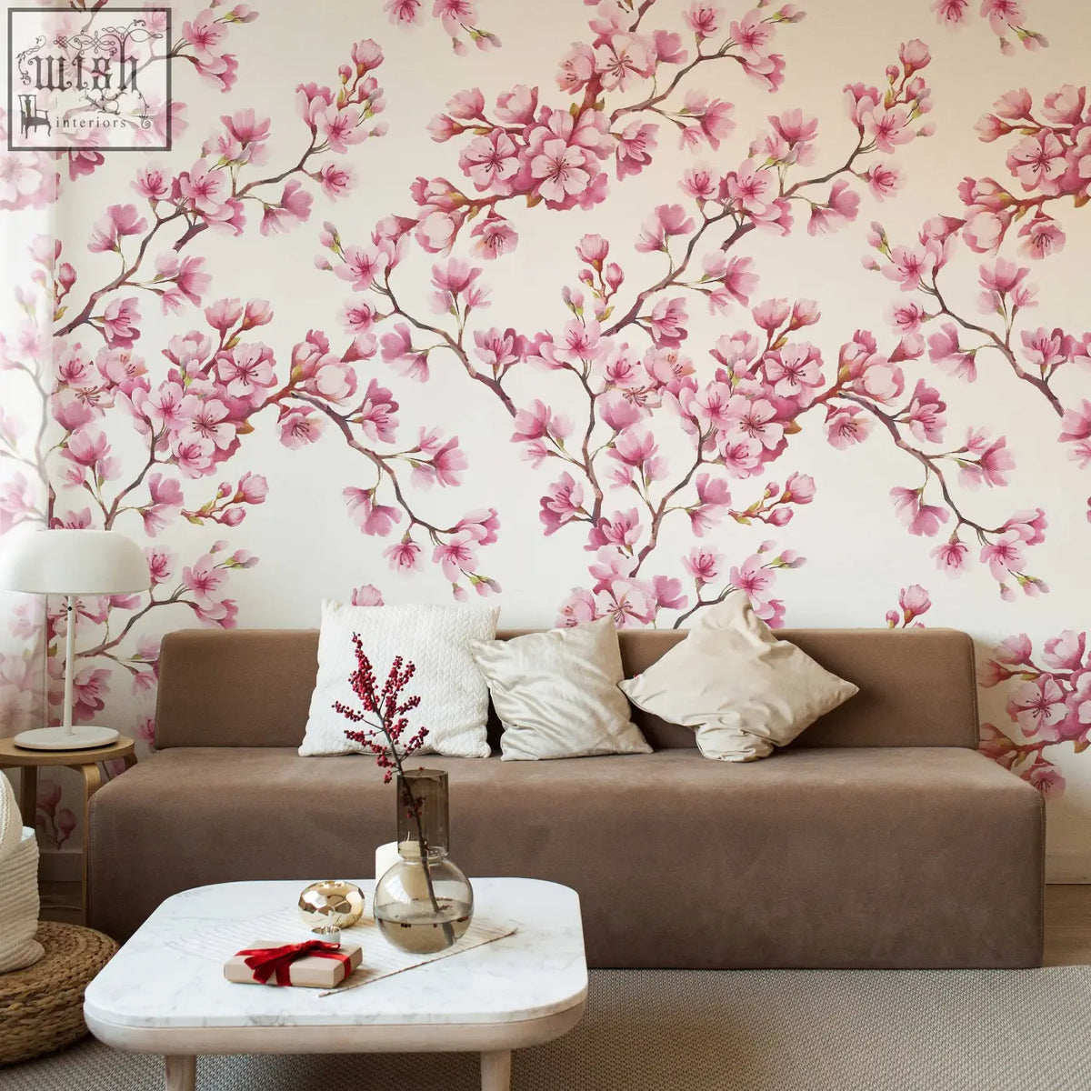 Brown upholstered sofa with beige and white pillows in living space featuring traditional paper cherry blossom mural wallpaper