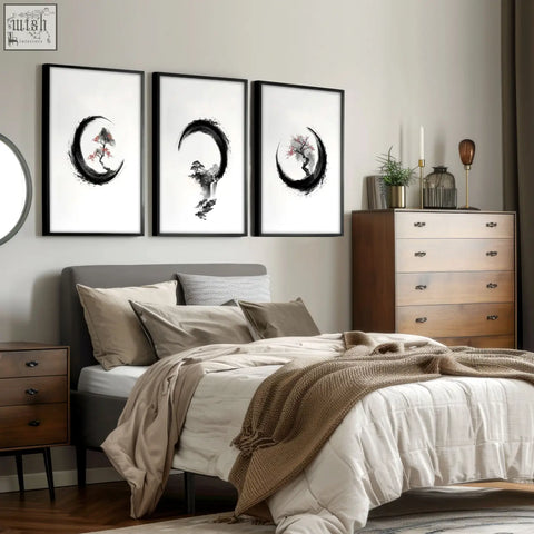 Three framed black and white cherry blossom painting ink art with stylized trees in crescent moon shapes above bed