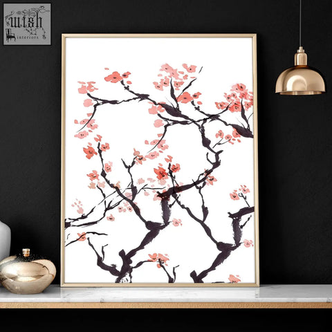 A set of 2 cherry blossom wall art prints featuring delicate pink flowers on white in slim gold-toned frames