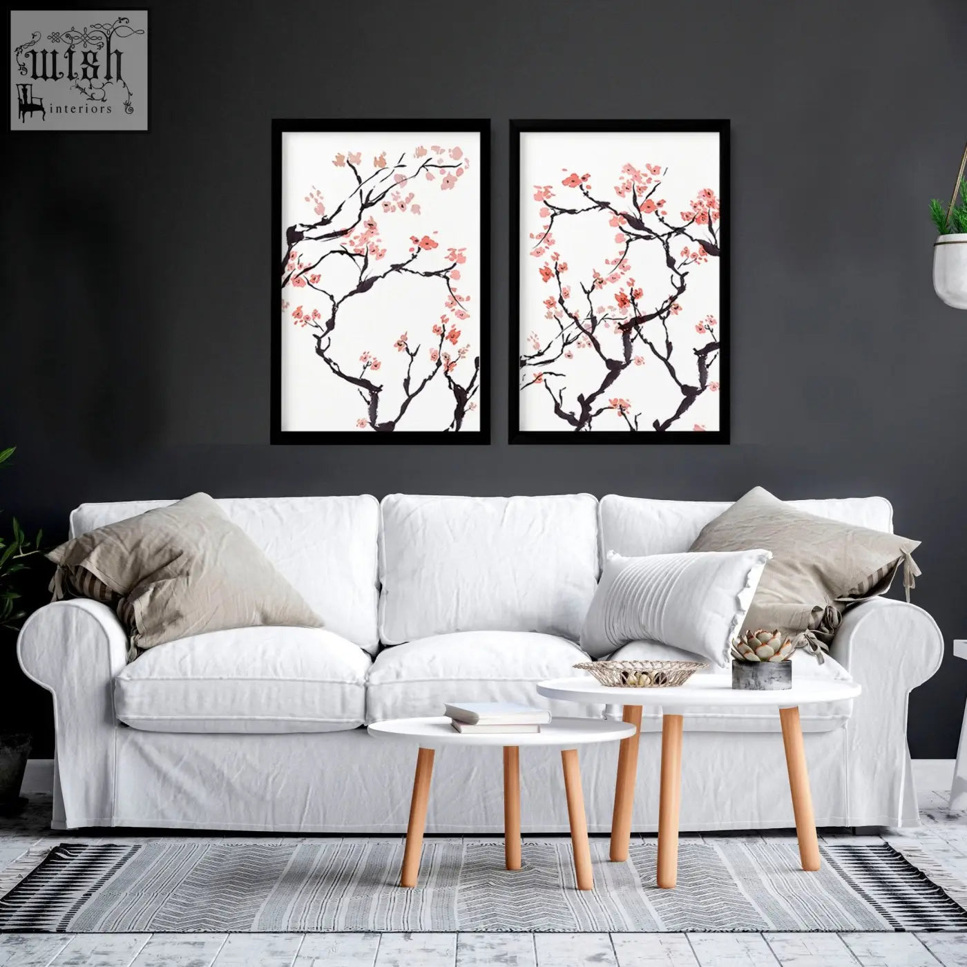Two cherry blossom wall art prints with black branches and pink flowers in sleek black frames for home decor