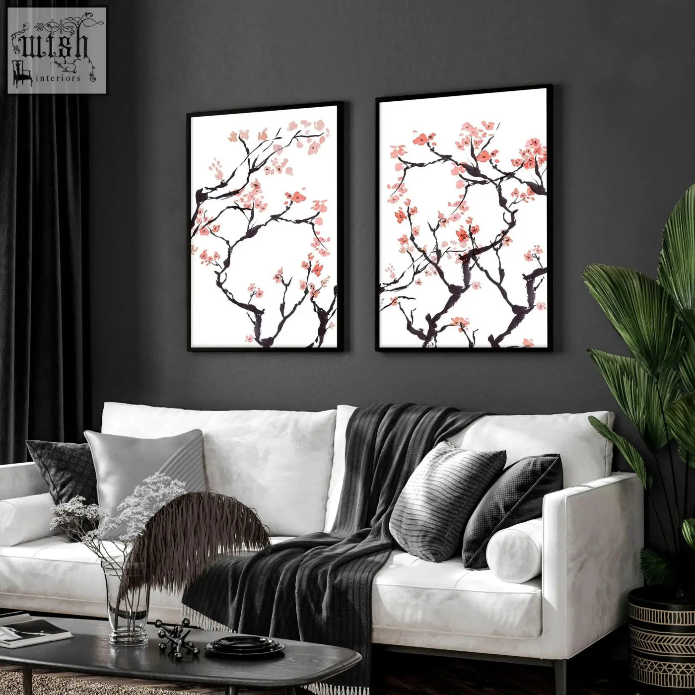 Two framed cherry blossom wall art prints with pink blossoms on dark branches in black frames on white background