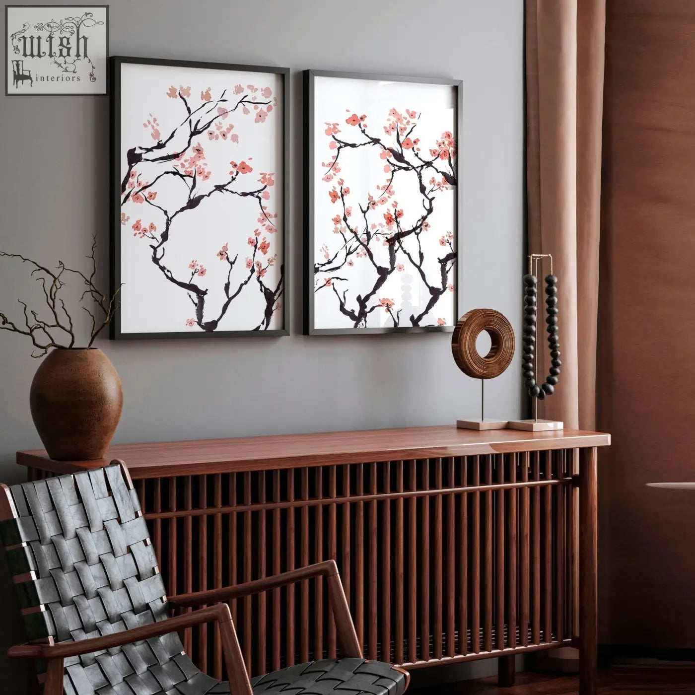 Two framed cherry blossom wall art prints with black branches and pink blossoms in sleek black frames