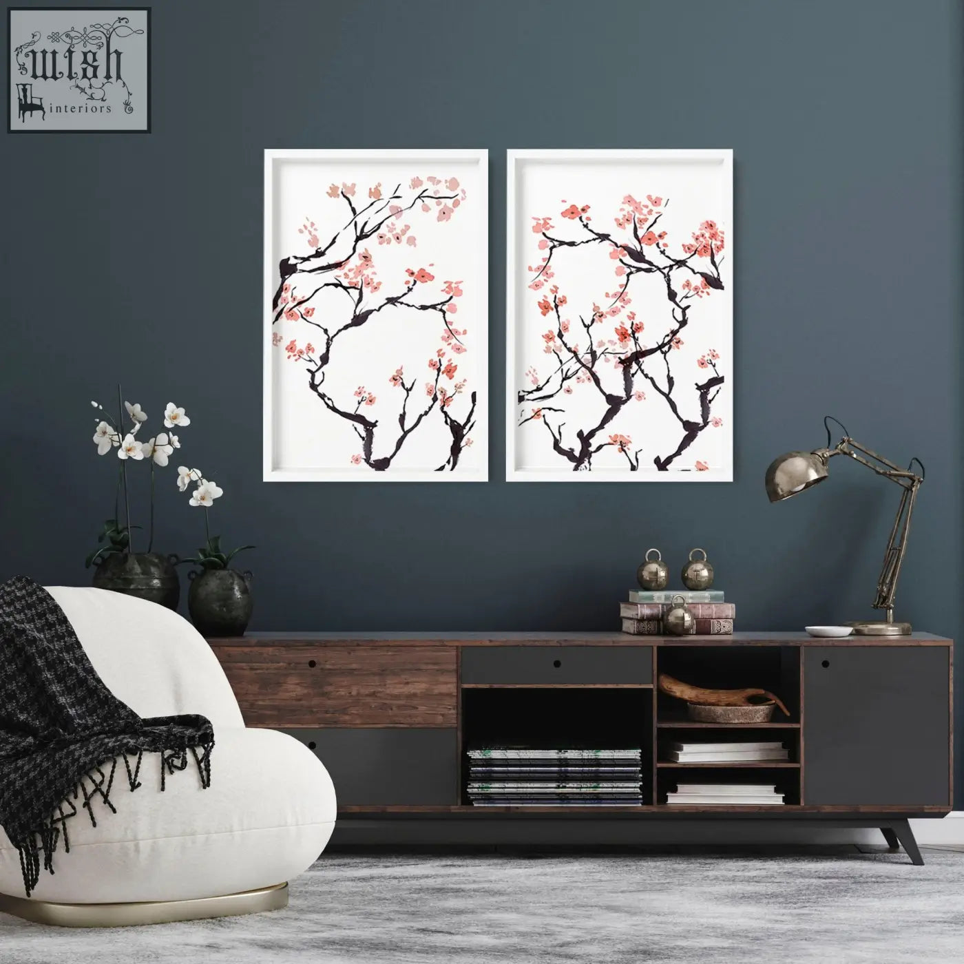 Two cherry blossom wall art prints featuring black branches and pink blossoms in simple white frames