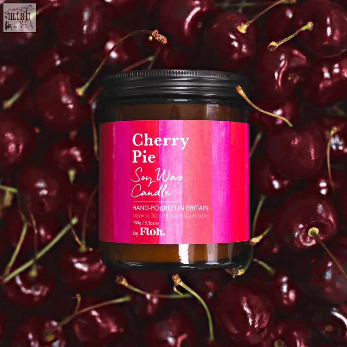 A vibrant pink-labeled cherry pie apothecary candle in a dark amber glass jar hand-poured in britain by floh