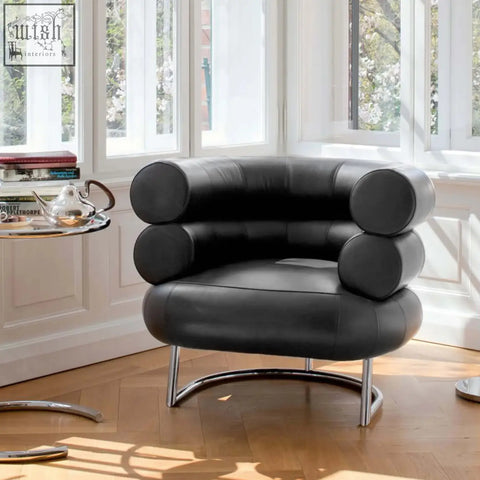 Black leather chester armchair with cylindrical segmented backrest and seat on curved chrome legs