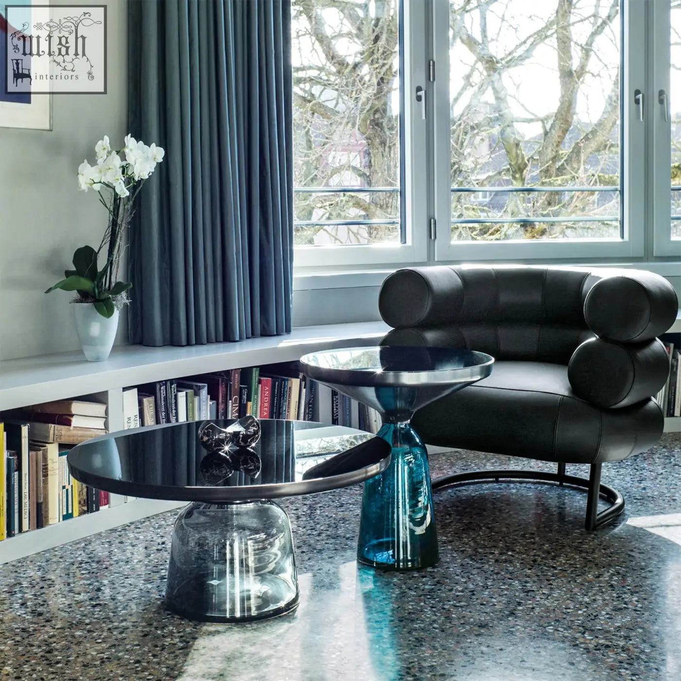 Black leather chester armchair with rounded segmented cushions and sleek metal frame perfect for modern living spaces