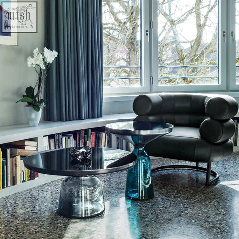 Black leather chester armchair with rounded segmented cushions and sleek metal frame perfect for modern living spaces