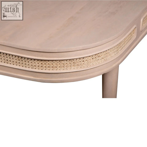 Beige wooden coffee table with a woven cane accent strip along curved edge featuring natural materials