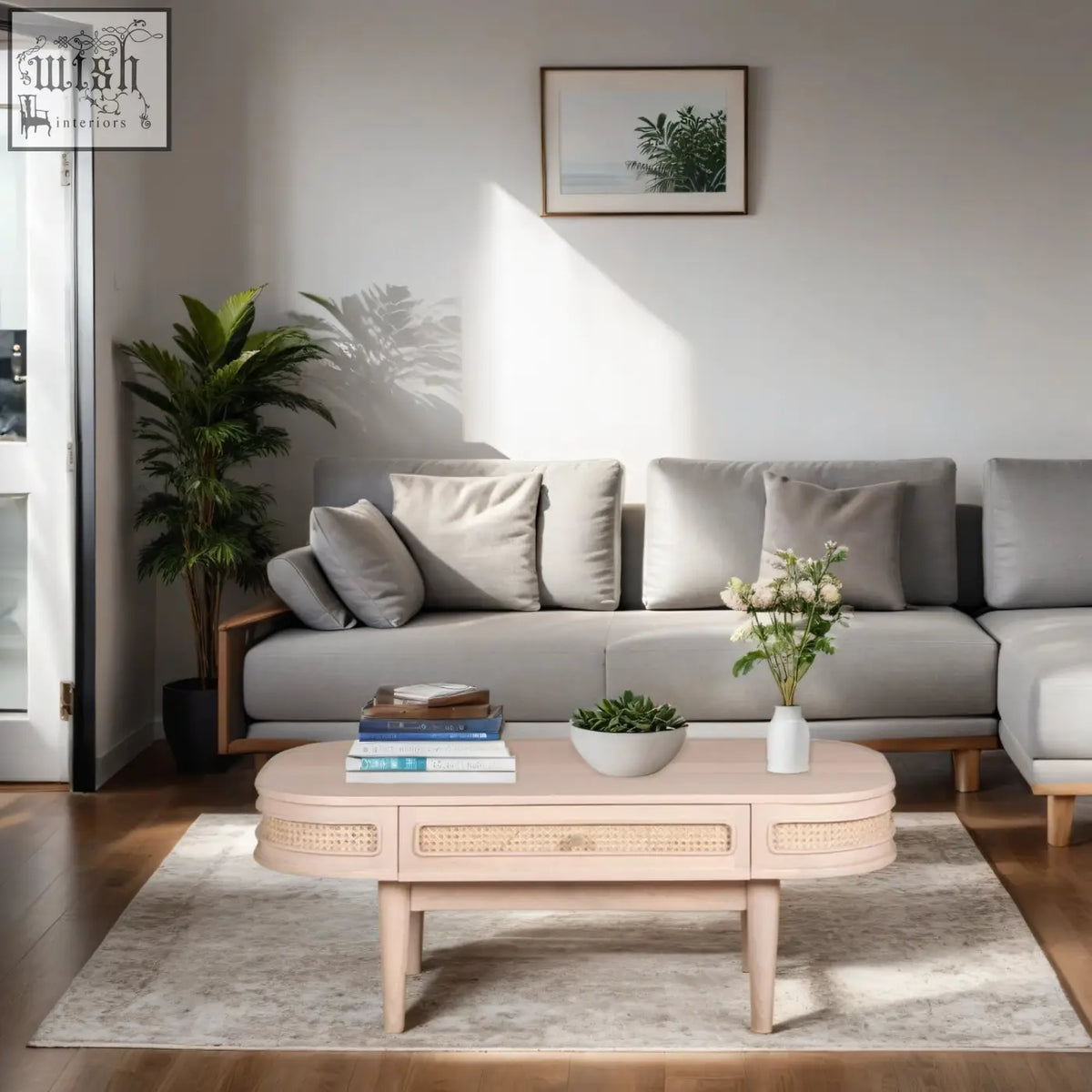 Pastel pink chester cane and wood coffee table with woven cane accents and slender legs featuring natural materials