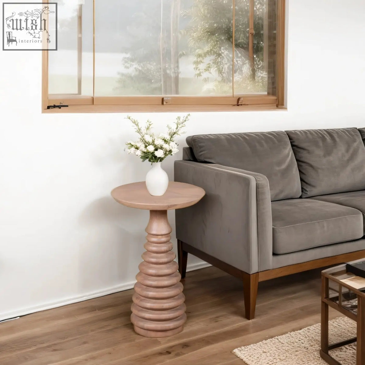 A chester cane mango wood pedestal side table in light pink with a twisted column base and smooth top surface