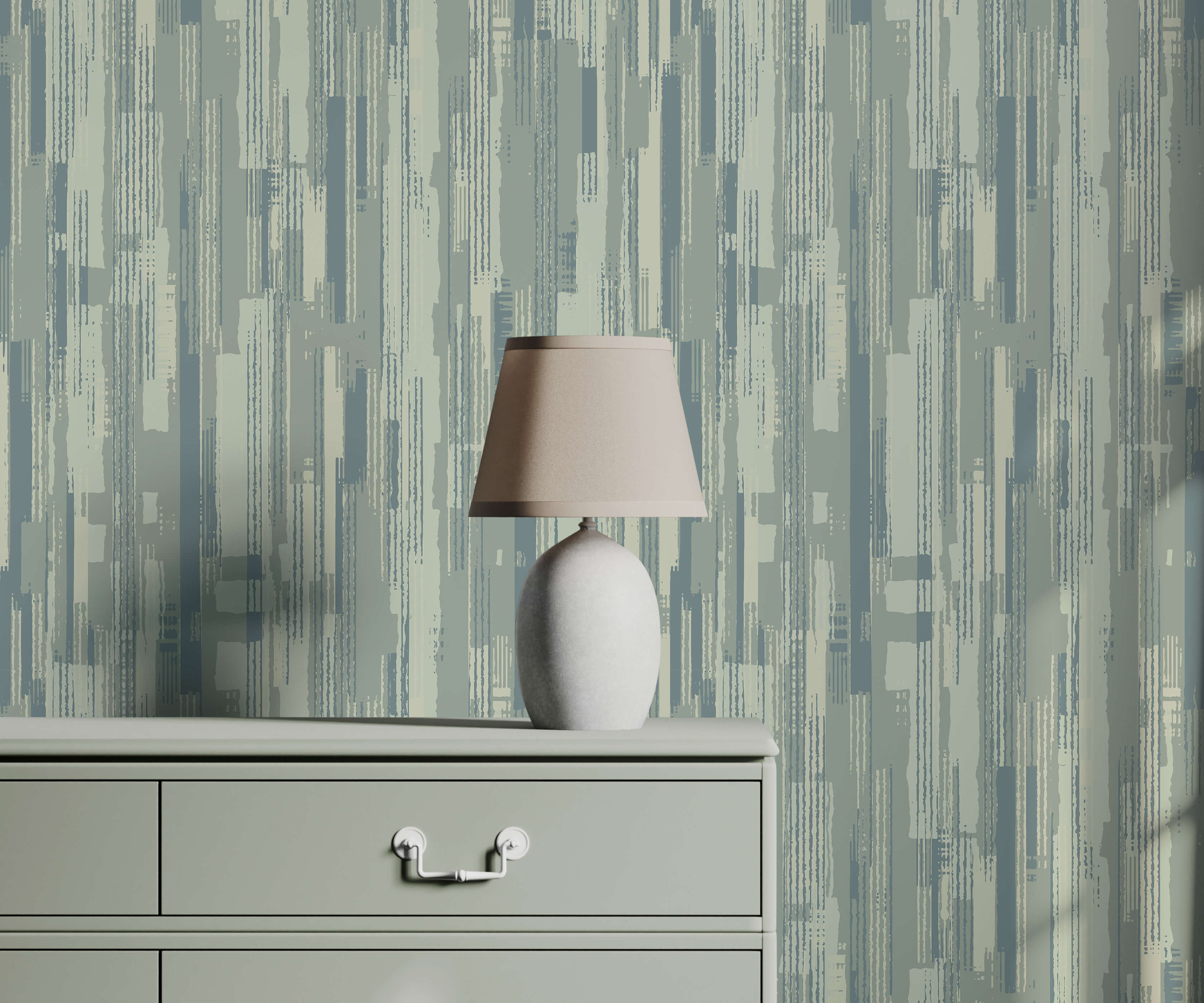 A sleek off-white ceramic table lamp with a soft beige fabric shade on a light gray dresser named chester