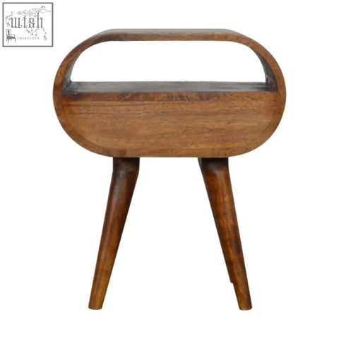 A sleek wooden side table with tapered legs and a smooth warm chestnut finish in an oval shape