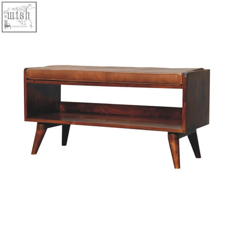 Chestnut bench with brown leather seat pad wooden frame and lower shelf with tapered legs for extra storage