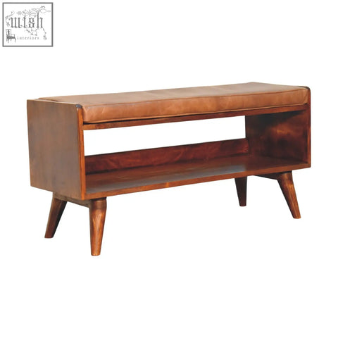 Chestnut bench with brown leather seatpad and lower shelf on tapered wooden legs for stylish seating