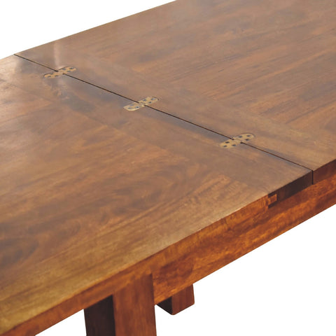 Chestnut butterfly dining table with rich brown wooden polished surface and visible grain patterns
