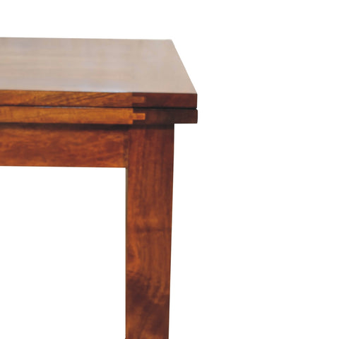 Chestnut butterfly dining table made of rich mahogany wood with a smooth polished finish and visible grain patterns