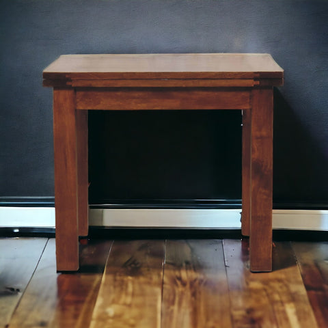 A sturdy rectangular wooden end table with warm brown finish and visible wood grain from chestnut butterfly dining table line