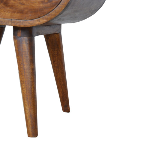 Chestnut circular bedside table with warm brown wood top and legs and matte gray metal side panel mid-century modern style
