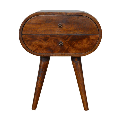 A sleek chestnut circular bedside table with oval shape, two drawers, and tapered wooden legs