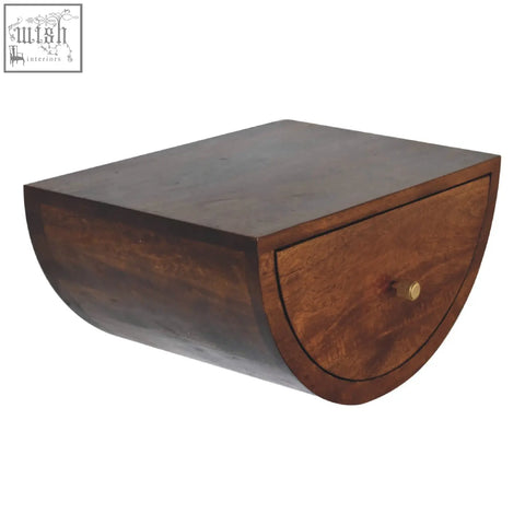 Dark brown wooden chestnut crescent floating bedside table with curved shape and single drawer with brass knob