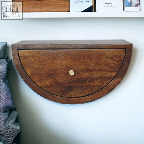Chestnut crescent floating half-moon wooden bedside table with warm brown finish and brass knob wall-mounted drawer