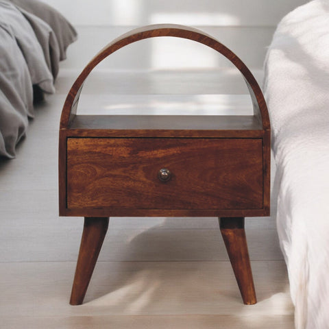 A rich dark brown wooden chestnut dome bedside table with a curved top and tapered legs perfect for nighttime use