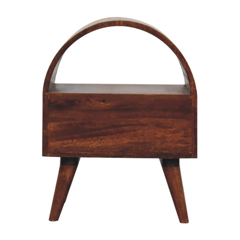 Chestnut dome bedside table with a sleek dark brown wooden magazine rack featuring a curved top handle and tapered legs