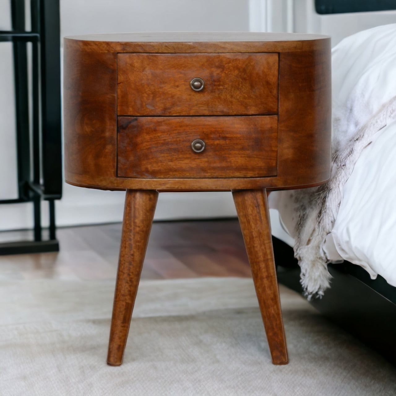 Mid-century modern chestnut rounded bedside table with two drawers and tapered legs in warm chestnut finish