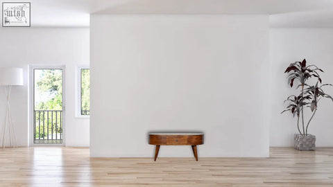 Chestnut rounded coffee table with sleek oval shape tapered legs and smooth finish made of solid mango wood