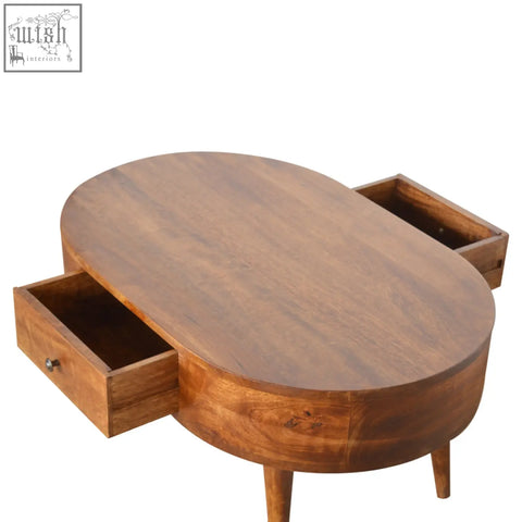 Warm-toned rounded coffee table with two side drawers, slender legs, made from solid mango wood for living rooms