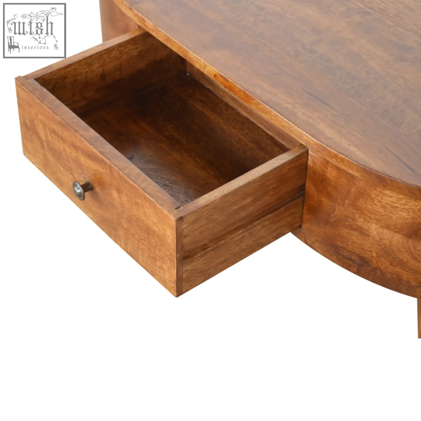 Warm-toned solid mango wood rounded coffee table with curved top and open drawer with metallic knob