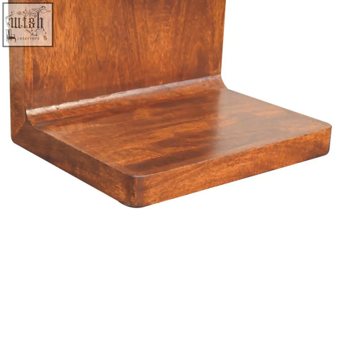 Rich brown wooden floating shelf with smooth polished finish and grain patterns on chestnut rounded bedside table