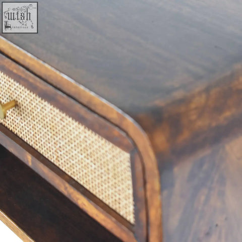 Dark wood wall mounted bedside table with woven cane drawer front and brass handle made of solid mango wood